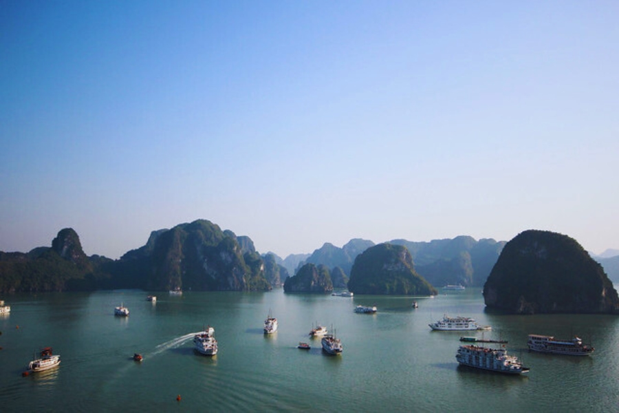 Boats cruising through limestone islands on Halong Bay Day Cruises by Auasia Travel
